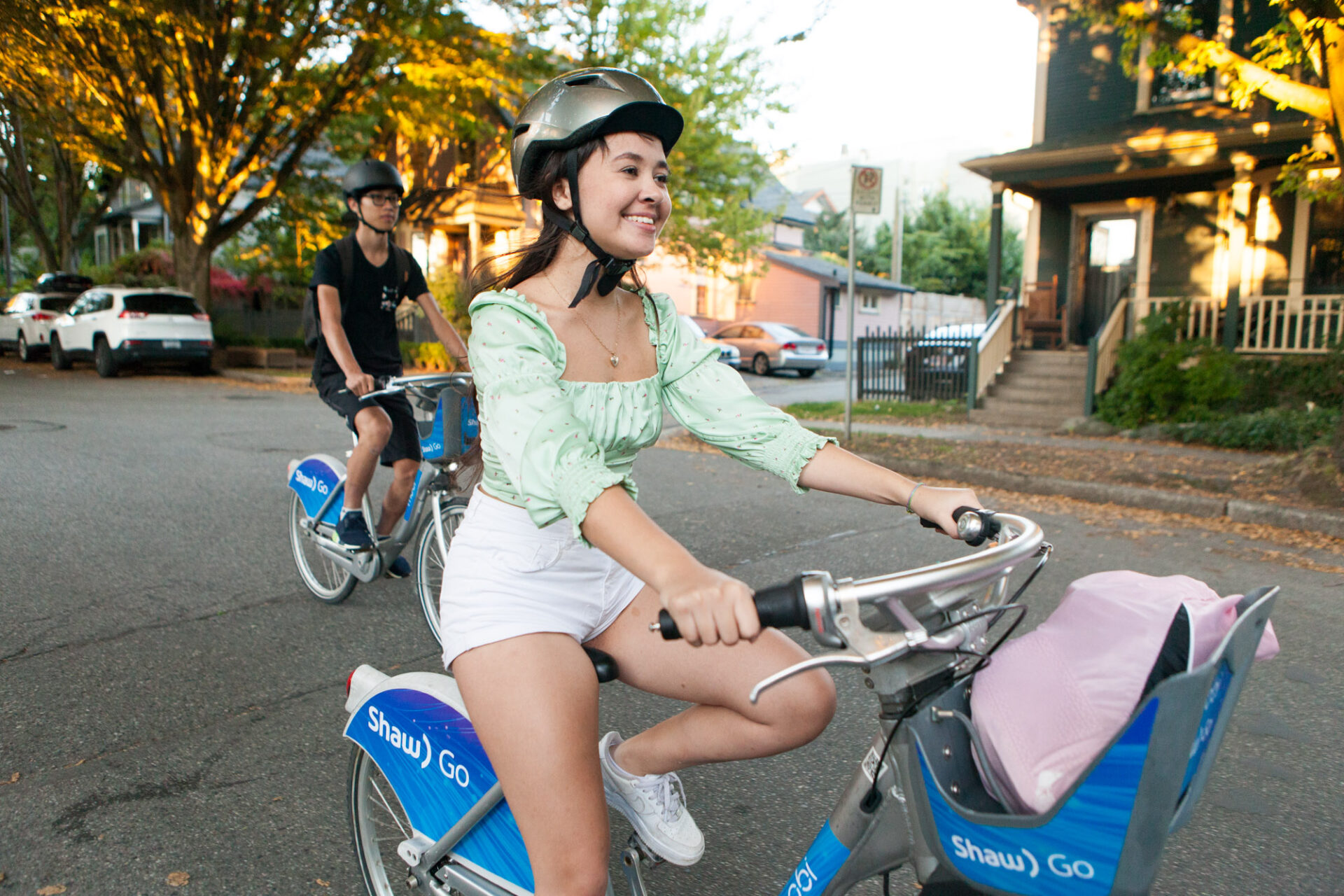 A young woman smiles as she rides with her boyfriend in Strathcona.